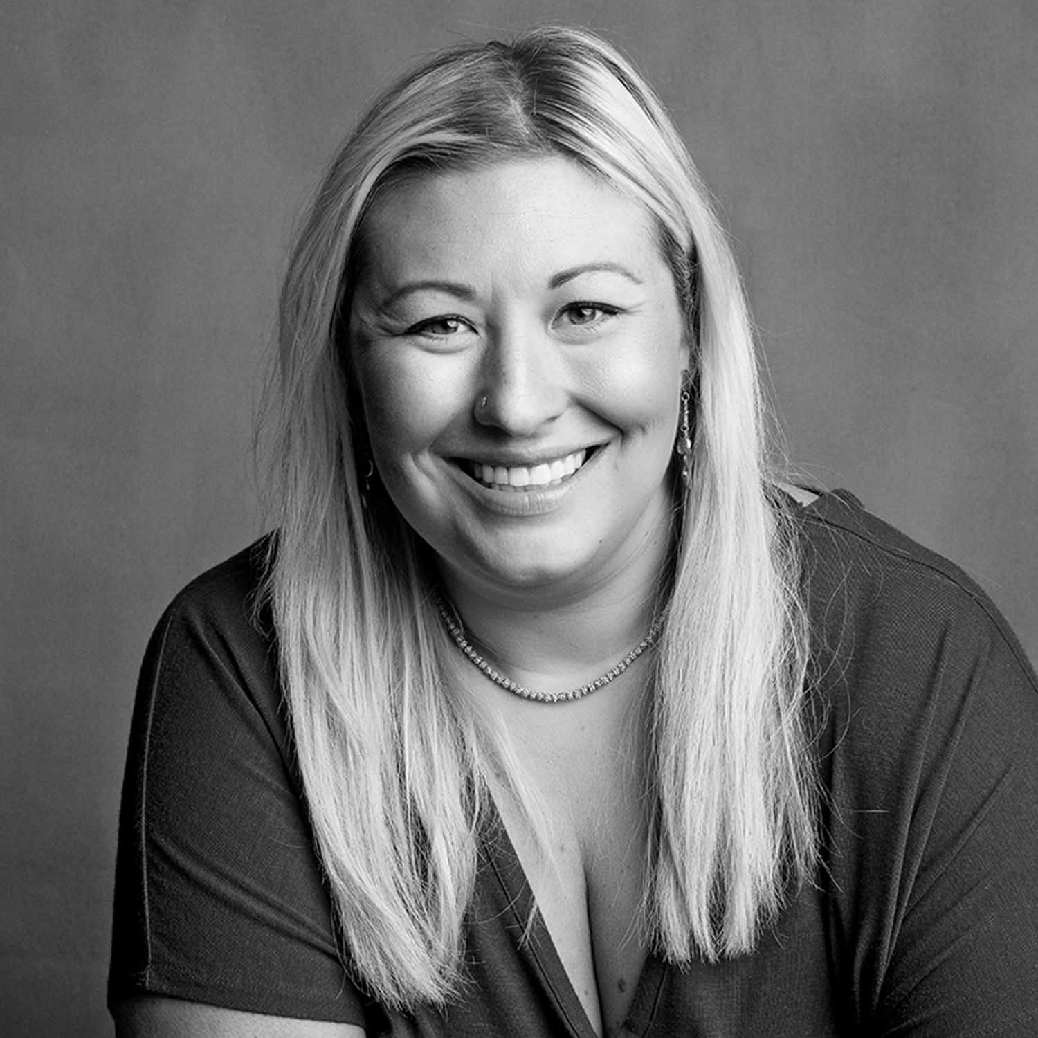 Portrait of Ashley, a professional stylist at Joe's Salon, showcasing their expertise and style.