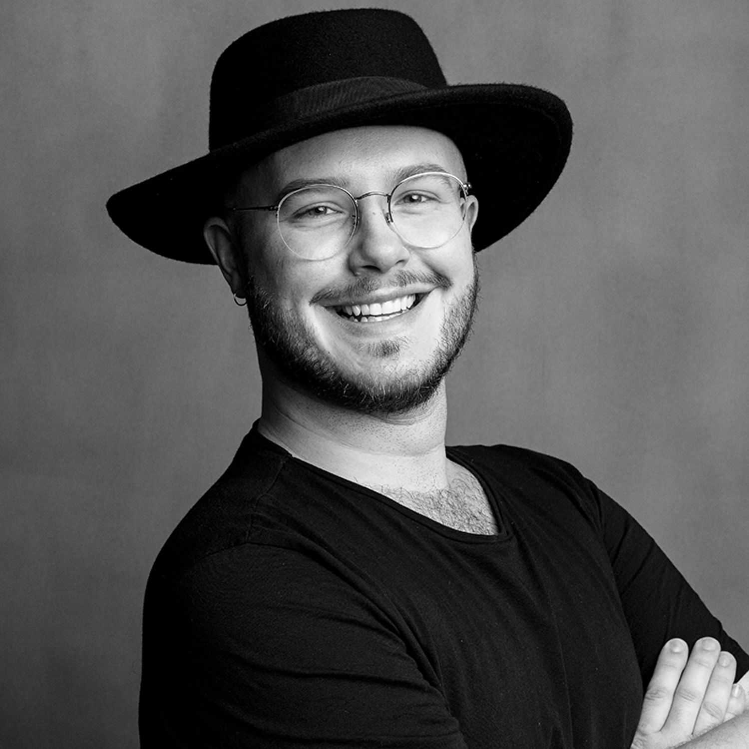 Portrait of Jesse, a professional stylist at Joe's Salon, showcasing their expertise and style.