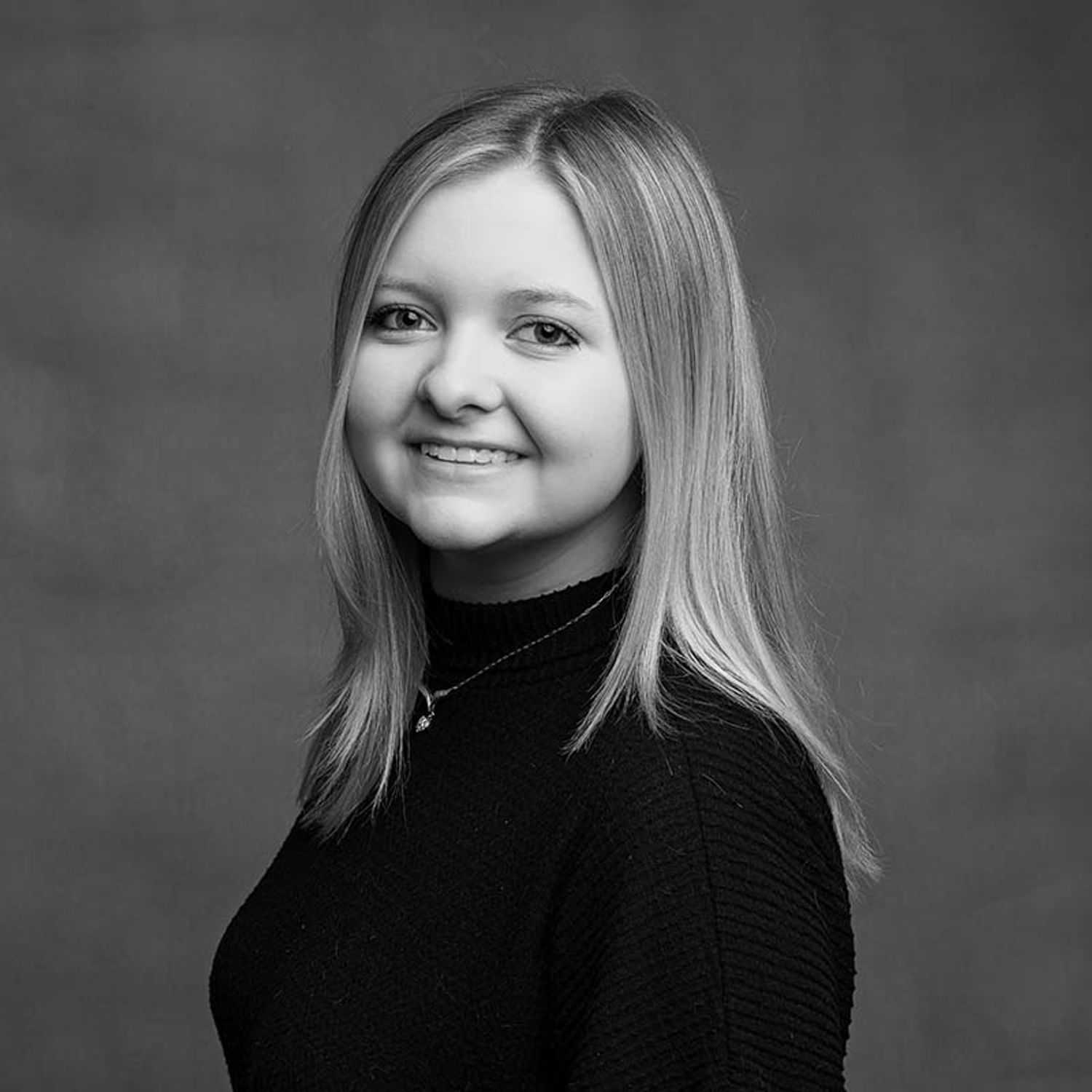 Portrait of Sara, a professional stylist at Joe's Salon, showcasing their expertise and style.